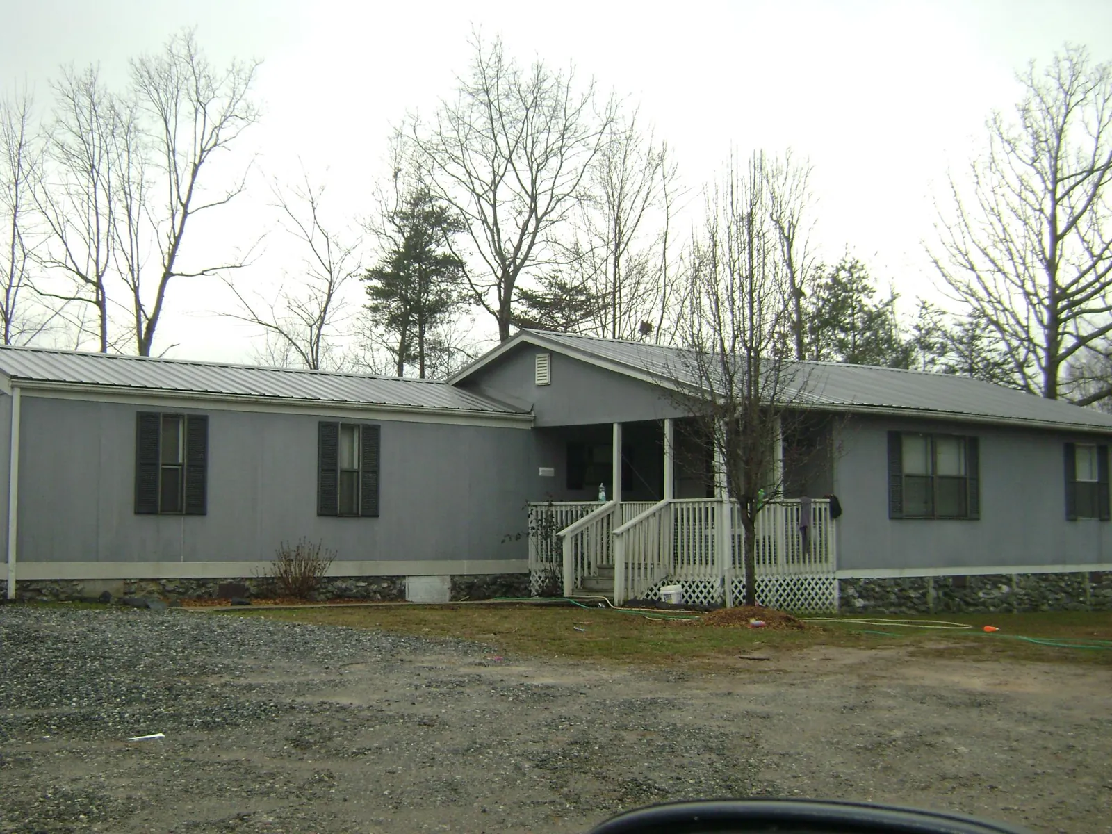Metal roof over a manufactured home with a covered front porch in Lawrenceburg